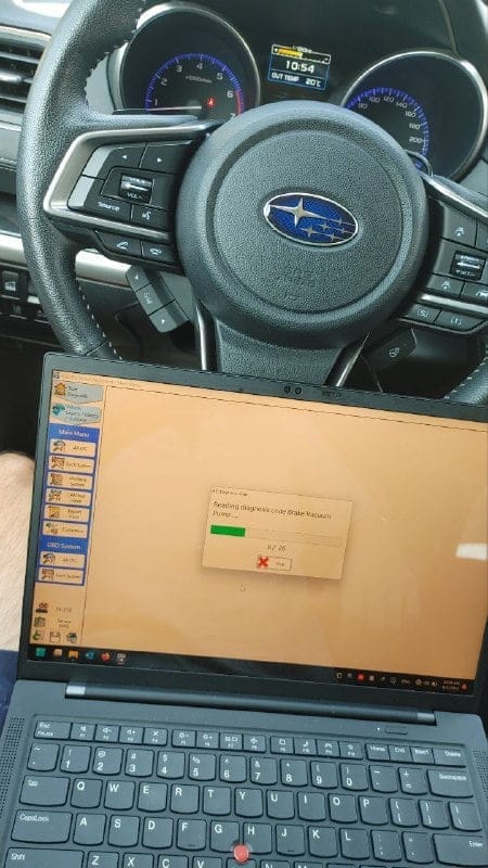 Специалист извършва компютърна диагностика на автомобил Subaru с помощта на съвременно оборудване.